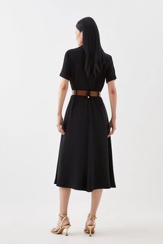 An ode to sophistication and timeless design, soft tailoring immerses this dress with short sleeves, a notched collar and waist belt adding touches of refinement above and a graceful skirt that flows to a midaxi hemline below. Perfect for emanating poise at professional events and special occasions alike.Soft TailoringShort SleevedNotched collar and waist belt Black Belted Midi Dress For Semi-formal Occasions, Classic Belted Shirt Dress For Semi-formal Occasions, Knee-length Belted Shirt Dress For Semi-formal, Elegant Midi Dress With Belted Cuffs For Daywear, Chic Belted Shirt Dress For Work, Formal Collared Belted Dress With Belted Cuffs, Semi-formal Fitted Midi Dress With Tie Waist, Classic Midi Dress With Belted Cuffs For Office, Fitted Midi Dress With Tie Waist For Semi-formal Occasions