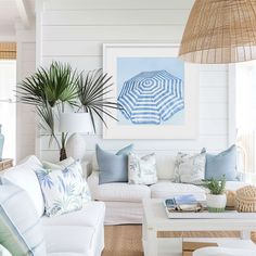 a living room filled with lots of white furniture