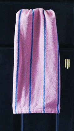 a pink and blue towel hanging from a hook