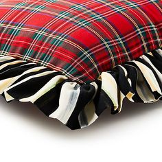 a red and black plaid pillow with ruffled edges