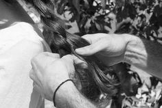 a man cutting another mans hair with scissors