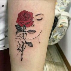 a woman's arm with a rose tattoo on the left side of her leg