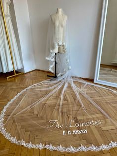 the wedding veil is sitting on top of a mannequin in front of a mirror