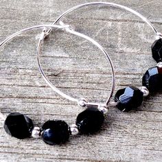 These handcrafted black hoop earrings are perfect for everyday wear! Silver plated 30mm hoops strung with gorgeous faceted Black Czech glass beads. Simply stunning! Item is carefully packaged and shipped via USPS in a sturdy protective mailer. Check out more fabulous jewelry and enter my shop here: https://www.etsy.com/shop/jewelbytessyla View the positive feedback I've received from customers and check out some beautiful art prints for nursery and home at my print shop, Tessyla: https://www.ets Black Bead Earrings, Black And Silver Earrings, Black Hoop Earrings, Tropical Necklace, Pink Gemstone Necklace, Fan Necklace, Black Hoops Earrings, Abalone Earrings, Black Earrings Dangle