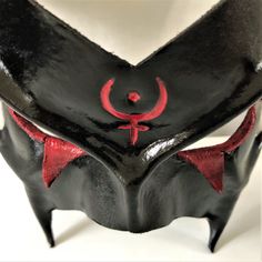 DESCRIPTIONCosPlay the Greek God of War, God of the Underword, or a Demonic entity. Airbrushed in black with red detailing. Use this costume accessory for demon LARP, Halloween party, circus, Renaissance Faire, parade, add to a Carnival Costume! Awesome for Halloween, Cosplay conventions, Renaissance Faire, SCA, Greek God Cosplay. Any color. Waterproofed leather, glossy or matte finish, & several choices to affix the mask (cord, elastic, ribbon, waterproof cord, stick, or no holes for adhesive).