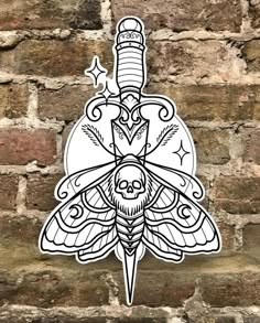 a sticker on the side of a brick wall with a drawing of a moth