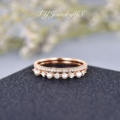 an image of a wedding ring with pearls