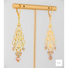 Add a touch of elegance and romance to your look with these stunning Amber glass filigree dangle earrings. The shimmering, faceted amber glass beads perfectly complement the lovely gold-plated filigree and lever backs, creating a lightweight and secure fit. Enhance your outfit with the timeless beauty of Amber glass filigree dangle earrings. The delicate filigree detailing and sparkling amber glass beads add a touch of sophistication and romance to any ensemble. These earrings, measuring at 2.75 Elegant Gold Chandelier Earrings With Dangling Beads, Elegant Chandelier Earrings With Dangling Beads For Celebration, Nickel-free Czech Glass Earrings For Wedding, Elegant Pierced Earrings With Czech Glass, Elegant Czech Glass Pierced Earrings, Elegant Czech Glass Earrings For Pierced Ears, Nickel-free Czech Glass Wedding Earrings, Elegant Czech Glass Earrings, Elegant Dangle Beaded Earrings