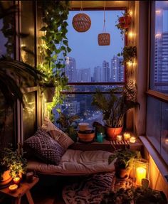 an apartment balcony with plants and candles on the windowsill, lit by string lights