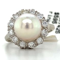 14k White Gold Round Diamonds And Pearl Ring  Ring Size 5.5 4.2 Grams  Center Stone: 8.5MM Round Pearl Round Cut Diamonds .5 Carats Total Weight Color: G-H Clarity: SI This is a vintage ring that shows off these bright older cut diamonds! if you have any questions or concerns please message me and I will get back to you as soon as possible! serial number: AJ57236 A Luxury Halo Pearl Ring For Anniversary, Classic Oval Pearl Ring With Halo Setting, Classic White Gold Pearl Ring With Vvs Clarity, Classic Pearl Ring With Halo Setting, Classic White Halo Ring With Round Stone, Formal Round Pearl Ring With Halo Setting, Classic White Pearl Ring In Platinum, Formal White Halo Ring With Round Stone, Classic White Platinum Pearl Ring