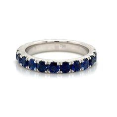 a white gold ring with blue sapphire stones