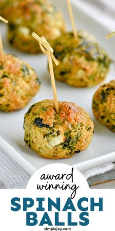 spinach balls with toothpicks in them on a white plate and text that reads award winning spinach balls