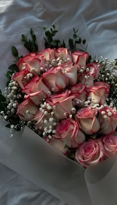 a bouquet of pink roses and baby's breath