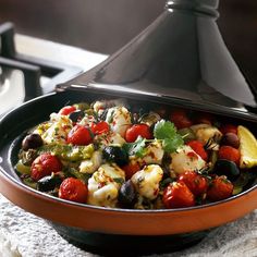 a bowl filled with lots of food on top of a counter next to a stove