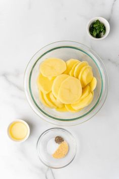 sliced mangoes in a glass bowl next to other ingredients