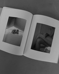 an open book with black and white photos on it's pages, showing two nude women