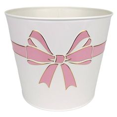 a white cup with pink ribbon on it