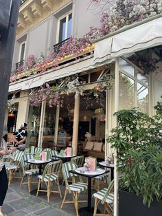 the outside of a restaurant with tables and chairs