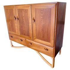 a wooden cabinet with two doors and three drawers