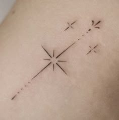 the back of a woman's shoulder with three crosses and arrows tattoo on it