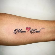 a man and woman's arm with the words mom and dad tattooed on it