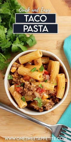 a white bowl filled with pasta and meat on top of a wooden cutting board next to a fork