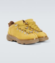 Find BURBERRY Leather Hiking Boots on Editorialist. Upper: leather. Lining: fabric. Sole: fabric insole, rubber sole. Toe shape: round toe. Made in Italy. Includes: shoe box. Designer color name: Manilla. Closure: lace-up. Trim: brass, polyester.