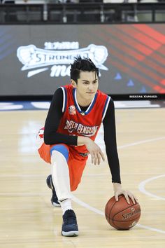 a young man is playing basketball on the court