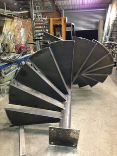 a large metal spiral staircase in a warehouse