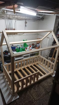 an unfinished bed frame in a garage