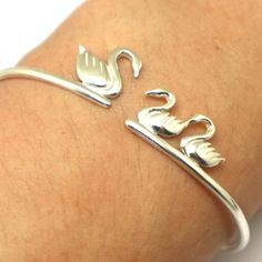 "Silver Mother and Child Swan Bracelet is handmade with its own uniqueness. It can be bought as a gift for any occasion like birthday gift, wedding gift, travel gift, souvenir and etc. If you need rose gold plating or yellow gold plating, please contact us, we will advice you on the additional fees applicable. Base Material: Sterling Silver Size: 15mm (Approximately) Bangle wrist size: Adjustable / Please give us your wrist circumference. Thickness: 1.5mm / 0.059 Inch Metal Stamped: 925 Crafting Handmade Flexible Bracelet, Handmade Flexible Jewelry For Gifts, Handmade Novelty Jewelry Bracelet, Novelty Handmade Bracelet As Gift, Handmade Novelty Bracelets For Gift, Novelty Handmade Bracelets For Gifts, Handmade Silver Bracelets For Birthday, Handmade Silver Bracelet For Birthday, Handmade Bangle Bracelets For Birthday