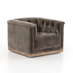 a gray velvet chair with wooden legs