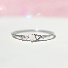 Our love is a forever type of thing! This ring features two petite hearts. It's feminine and simple and the perfect stacking ring. 18k gold plated, 18k rose gold plated, or rhodium plated over brass with a protective coating Cubic zirconia stones Available in sizes 5-8 Approx 3mm width Shop our entire Rings Collection here Unique Small Promise Rings, Cute Promise Rings Silver, Small Heart Ring, Alternative Promise Rings, Simple Promise Rings Silver, Dainty Promise Rings Silver, Small Rings Simple, Small Promise Rings, Promise Rings Simple Silver