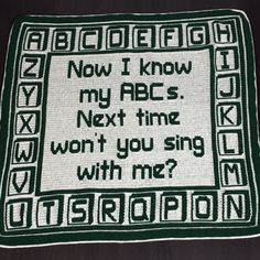 a crocheted afghan with words written in black and white on the front, which reads now i know my abcs next time won't you sing with me?