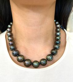 This beautiful black Tahitian pearl necklace ranges from 12 mm to 16.30 mm. The clasp has 114 round brilliant diamonds weighing 2.25 ct. The diamonds boast a color of E/F, are VS1 in clarity and are set in 18k white gold. A perfect piece for everyday wear! Black High Luster Necklace For Formal Occasions, Formal High Luster Black Necklace, Formal Black High Luster Necklace, Formal Black High Luster Necklaces, Luxury Tahitian Pearl Round Bead Necklace, Luxury Black Pearl Necklace With Round Beads, Luxury Black Tahitian Pearl Necklaces, Formal Black Tahitian Pearl Necklace, Formal Black Tahitian Pearl Jewelry