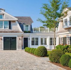 a large house with lots of windows and landscaping