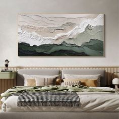 a large painting hanging above a bed in a bedroom