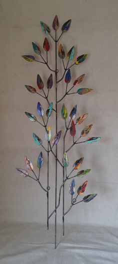 a metal tree with multicolored leaves on it