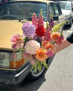 a bouquet of flowers in front of a parked car