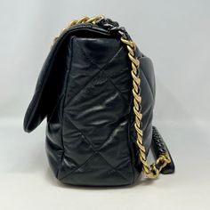 Chanel Maxi 19 Flap Bag with Bi-colored Chain Link Shoulder Strap, Interlocking CC Logo and Quilted Pattern (includes Dustbag) Designer = Chanel Color = Black Material = Lamb Skin Condition = Excellent Height = 10 Width = 14 Depth = 4.5" Class = Premier Location: Wilmette Item Number: 20201-73 Item ID: 300893 Category: Shoulder Bag Luxury Shoulder Bag With Chain For Office, Luxury Office Shoulder Bag With Chain, Luxury Chain Shoulder Bag For Office, Travel Bag With Chain Strap And Double Flap, Black Double Flap Bag For Office, Black Double Flap Shoulder Bag For Office, Black Double Flap Office Bag, Travel Bag With Double Flap And Chain Strap, Designer Top Handle Bag With Chain