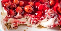 a dessert with cherries and whipped cream in it's pie dish, ready to be eaten