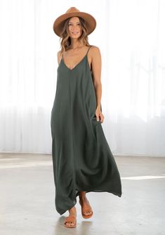 Dark Green Colored Tank Top style Maxi Dress. With pockets attached Chic Summer Maxi V-neck Dress, Casual V-neck Maxi Dress For Date Night, Chic V-neck Rayon Maxi Dress, V-neck Maxi Sundress For Day Out, Chic Unlined V-neck Maxi Dress, Casual Spaghetti Strap Maxi Dress For Loungewear, Chic Solid Color Slip Dress For The Beach, Chic Slip Dress For The Beach, Casual Maxi Dress With Spaghetti Straps For Loungewear