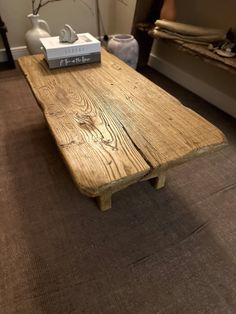 a wooden table sitting on top of a carpeted floor