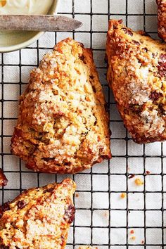 freshly baked muffins on a cooling rack next to a bowl of yogurt