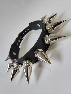 "Leather Choker with 9 chunky tree spikes size 1.80\" x 0.80\".Punk Goth Metal spikes size : 1.80\" high and 0.80\" diameter at the bottom . or 46 mm high and 20 mm wide at the bottom  Quality Leather Choker designed and hand crafted by me in Montreal for you Top quality hardware and Cow split leather that would last a lifetime I make it in size : X small 12\" to 14\" neck,Small 14\" to 16\" neck,Medium 16\" to 18\" neck, Large 18\" to 20\" neck    Please wrap any cord around your neck where the choker rests than measure the cord to get the size of your neck in inches or mm if you another size plz message me" Gothic Spiked Jewelry For Halloween, Gothic Halloween Jewelry With Spikes, Punk Jewelry With Spikes For Alternative Fashion, Punk Jewelry With Spikes, Punk Spiked Jewelry For Concerts, Punk Jewelry With Spikes For Concerts, Black Punk Jewelry With Spikes, Gothic Jewelry With Spikes For Alternative Fashion, Edgy Spiked Jewelry For Festivals