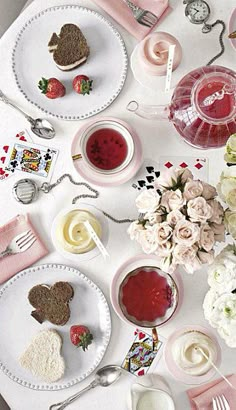 a table topped with plates and cups filled with food