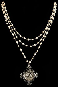 The Notre Dame de Lourdes Trinity Necklace features three strands of 5mm Freshwater Pearls hand wrapped in Sterling Silver chain. It is a medal that was given to Pilgrims to the Holy Waters and apparition site of Lourdes, France. The M in the center honors the Blessed Mother and the 12 Roses surrounding it are symbolic of the Apostles and the 12 Tribes of Israel. Regardless of your faith background, Her presence is a protective and healing balm and a holy medal is a tangible reminder of Her love Silver Multi-strand Jewelry With Pearl Pendant, Silver Medallion Jewelry With Pearl Chain, The Blessed Mother, Trinity Necklace, Lourdes France, 12 Roses, Healing Balm, Blessed Mother, Hand Wrap