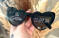 a pair of heart shaped sunglasses with the date written on them