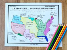 a map of the united states with colored pencils next to it on a table