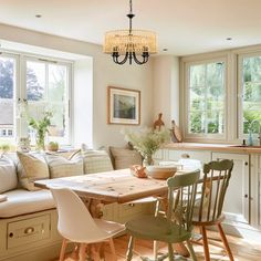 a living room filled with furniture next to a kitchen and dining room table in front of a window